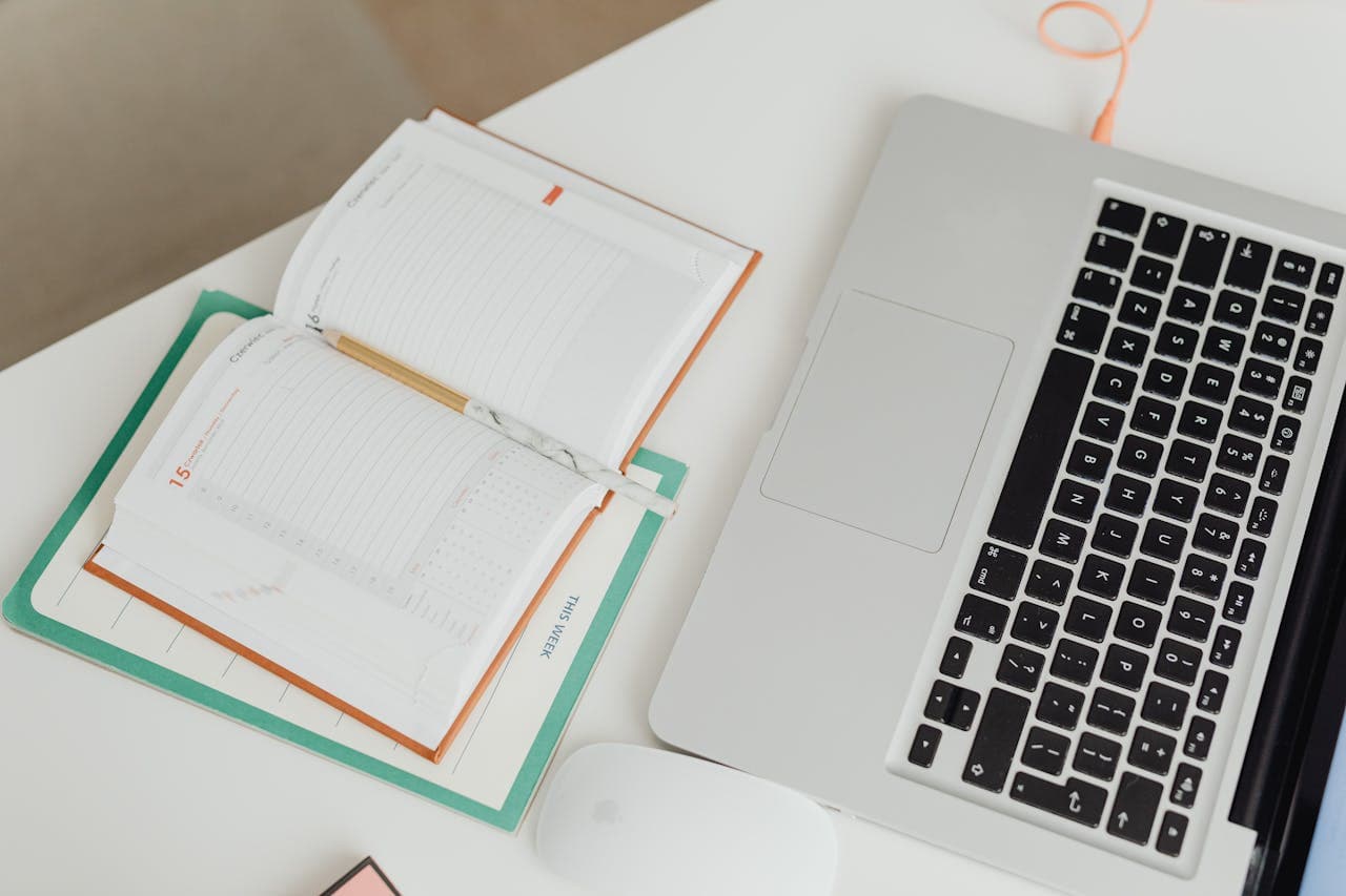 Organized workspace with planner and laptop showing a strategic approach to job searching